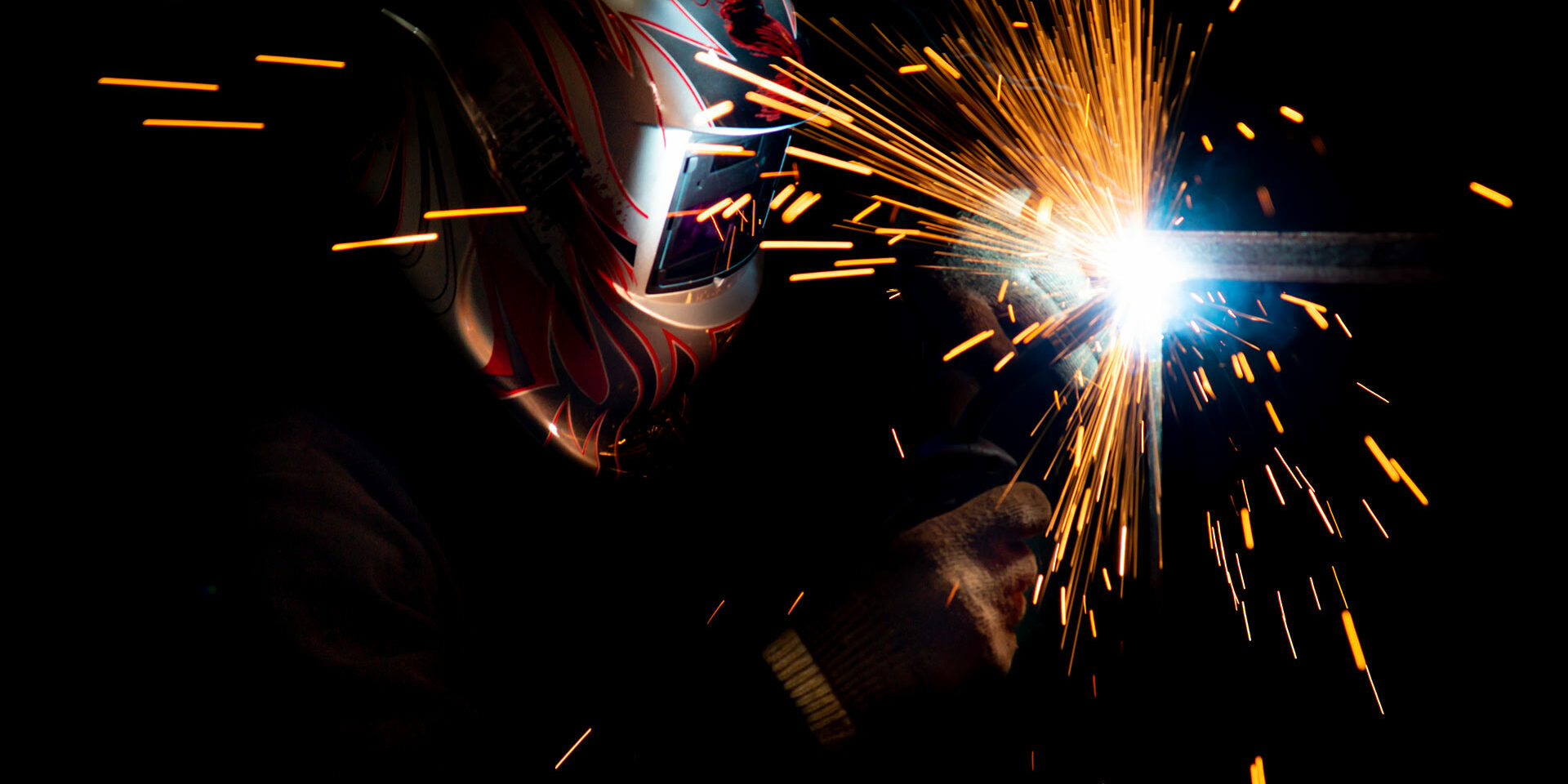 male-welder-mask-performing-metal-welding-photo-dark-colors-sparks-flying